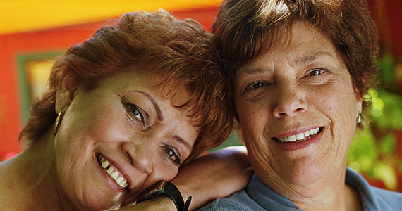 two Latino women together smiling