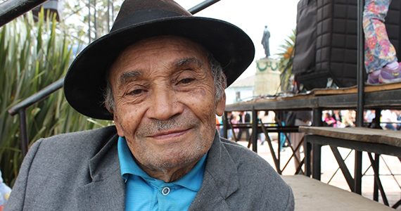 Older Latino man in hat