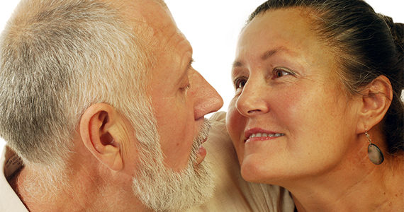 older Latino couple looking lovingly into each others' eyes