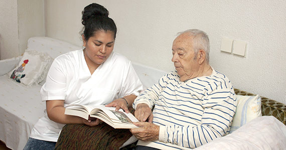 Caregiver taking care of older Latino man