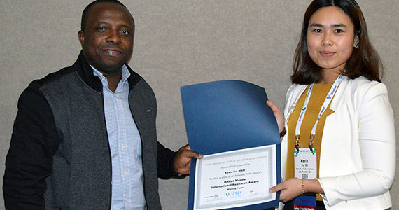 Kexin Yu accepts award at APHA meeting