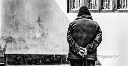 Older adult walking alone with his back turned