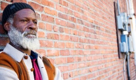 gentleman leaning against the wall