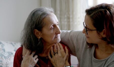 Woman with her arm around older woman