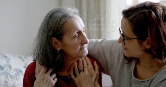 Woman with her arm around older woman