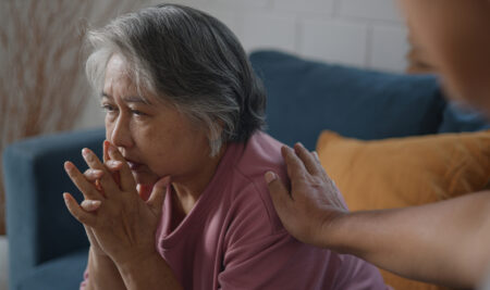 Asian mature woman with feeling depressed while talking to psychologist