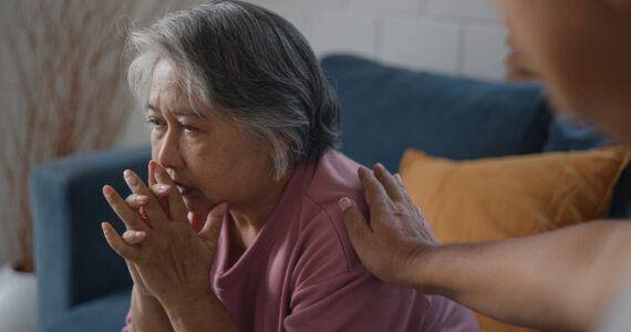 Asian mature woman with feeling depressed while talking to psychologist