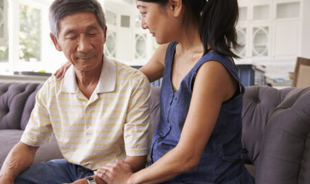 Adult Daughter Talking To Depressed Father At Home